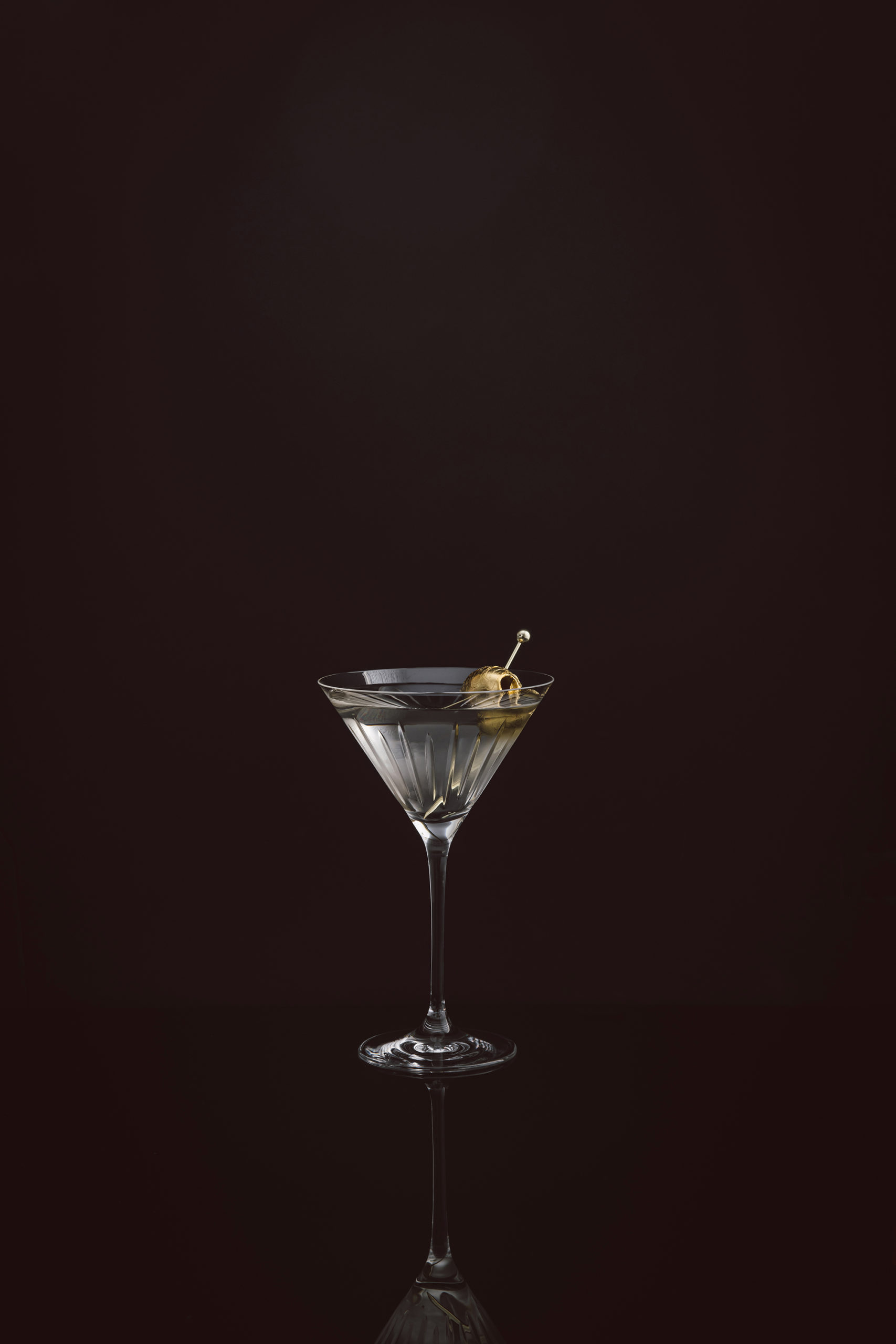 Martini on black with gold olive